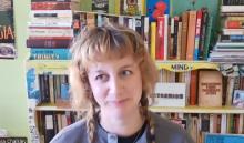 Olivia Chalkley in front of a bookshelf