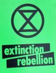 Extinction Rebellion logo of a black hourglass in a circle on a green background